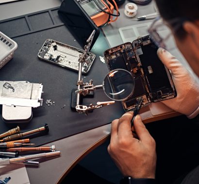 technician-carefully-inspect-the-internal-parts-of-the-smartphone-in-a-modern-repair-shop.jpg